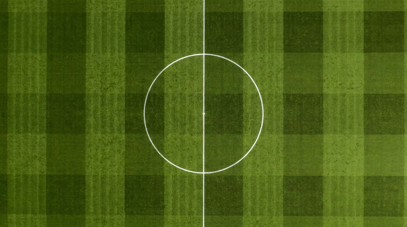 Overhead view of the centre circle and halfway line on an empty football pitch